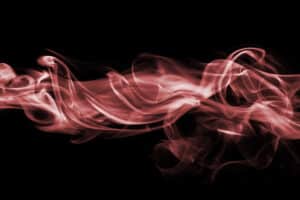 Elegant red smoke swirls on black background.