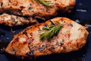 Grilled chicken breasts with rosemary and herbs.